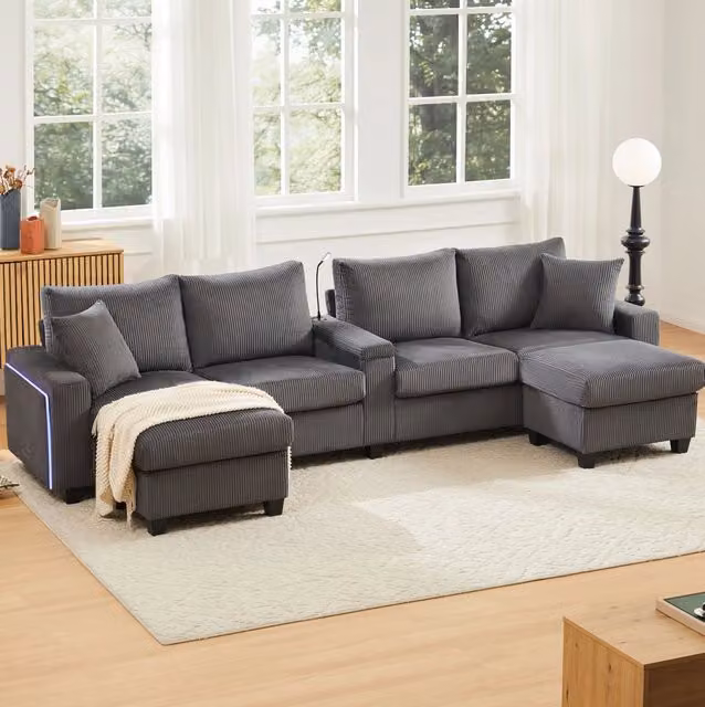 Divano a U ULEVR 334x128,5x81 cm in velluto a coste grigio con 2 pouf contenitore, LED, USB e Type-C