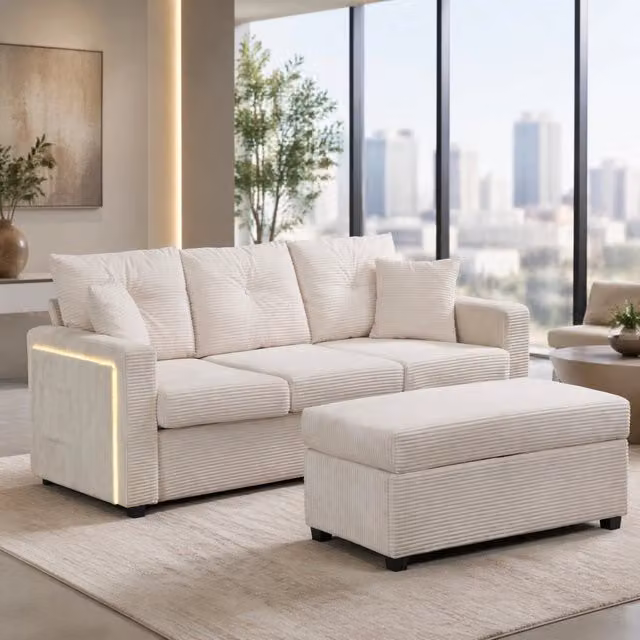 Divano angolare REDOM con illuminazione LED, pouf coordinato e cuscini, rivestimento in tessuto a coste beige
