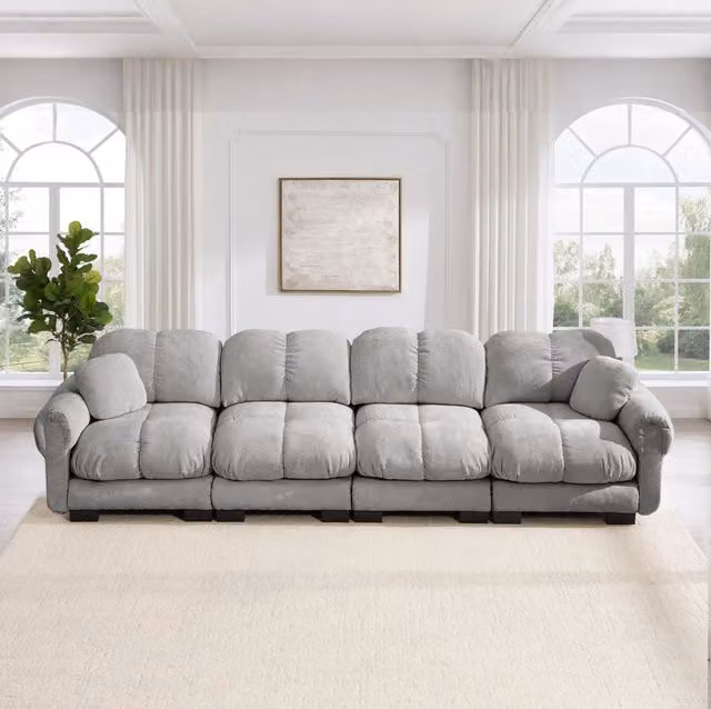 Divano modulare 330x86x90 cm in ciniglia con cuscini trapuntati; grigio chiaro