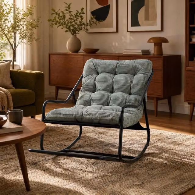 Poltrona a dondolo con pouf, struttura nera e cuscino verde chiaro