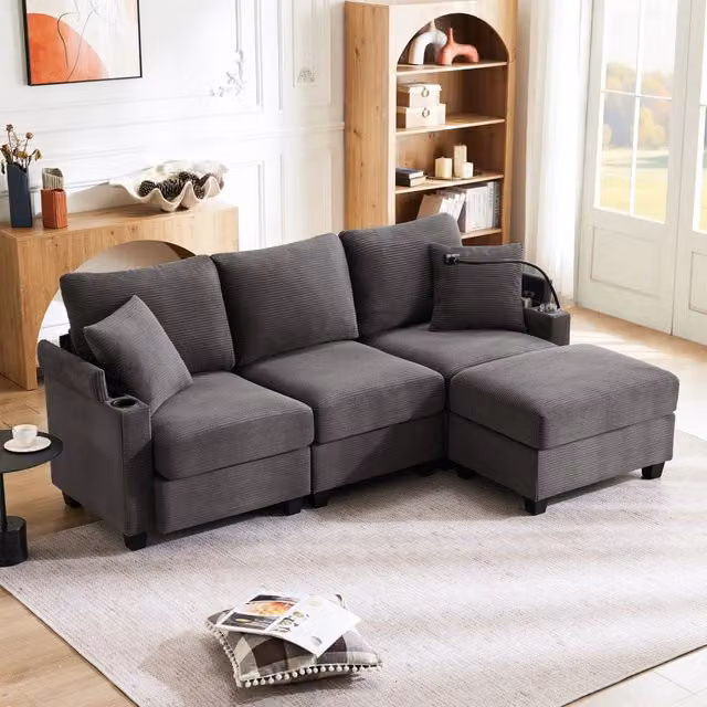 Divano angolare reversibile REDOM a 3-4 posti in velluto a coste grigio, con porta bicchieri e ricarica USB, L/P/H: 213,5 x 139 x 87 cm