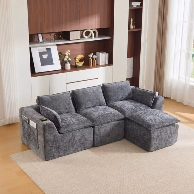 Divano modulare a L Mivray in tessuto grigio con pouf e cuscini coordinati per soggiorno o ufficio