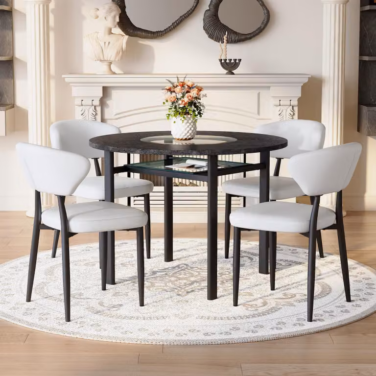 Set tavolo da pranzo rotondo STILVORA con 4 sedie realizzate in materialePoliuretanoe con schienale confortevole. Tavolo rotondo di 100 cm con finitura effetto legno nero. Set da pranzo per soggiorno, disponibile in nero e bianco