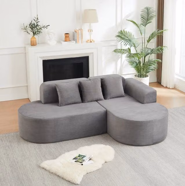 Divano angolare a L in velluto a coste grigio con chaise longue curva HOMVRA