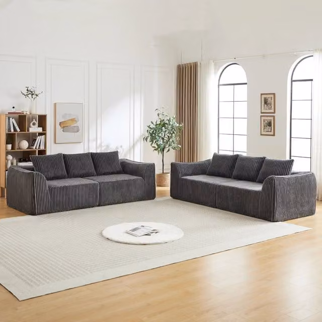 Divano modulare in velluto a coste con linee sinuose e seduta ampia, per soggiorno e relax quotidiano, grigio