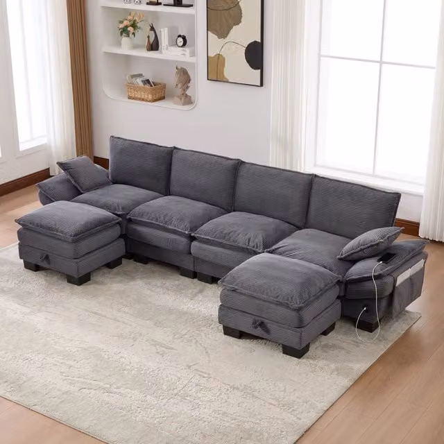 Divano modulare a L OKWISH da 4 posti in velluto a coste grigio con porta USB e pouf coordinato L/P/H: 330 x 132 x 84 cm