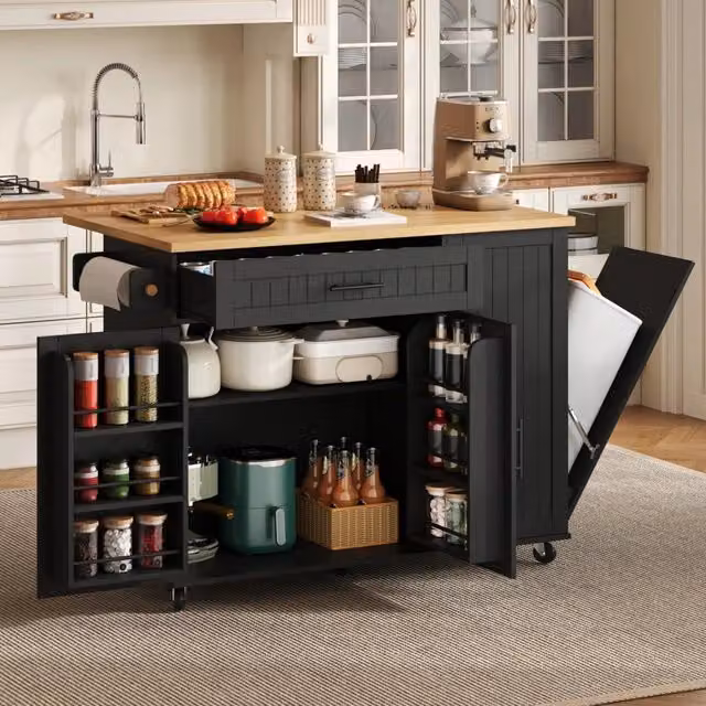 Isola cucina mobile in MDF nero con piano ribaltabile; vano pattumiera e ruote bloccabili; 130 x 70 x 93 cm