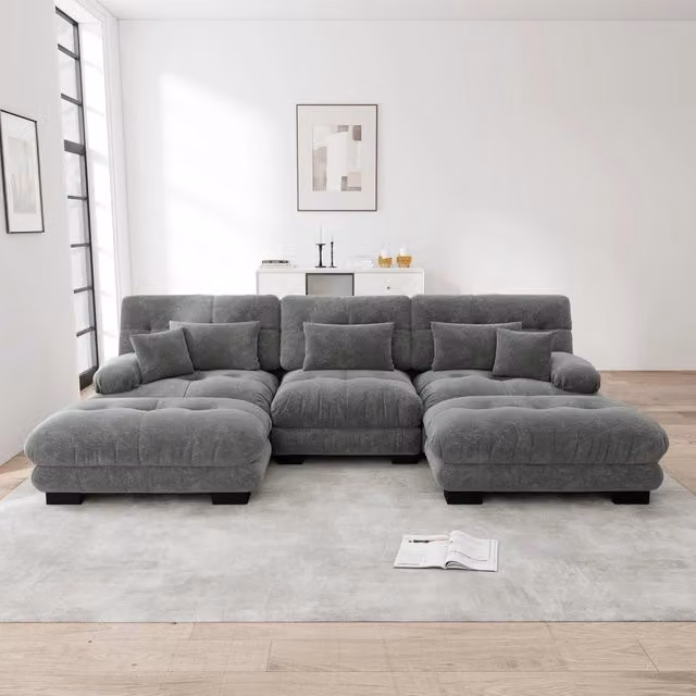 Divano componibile Mivray in velluto grigio con pouf coordinati e cuscini, configurabile a U, angolare o lineare, ideale per soggiorno e ufficio
