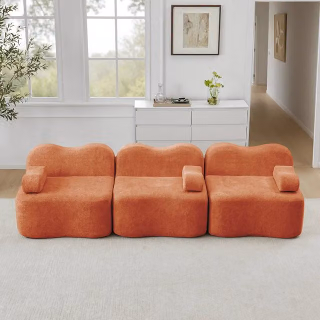 Divano modulare senza struttura con seduta profonda, schienali ergonomici e pouf collegabile in velluto arancione