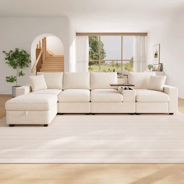 Divano angolare modulare OKWISH in tessuto beige con porta bicchieri, ricarica USB e cuscini inclusi