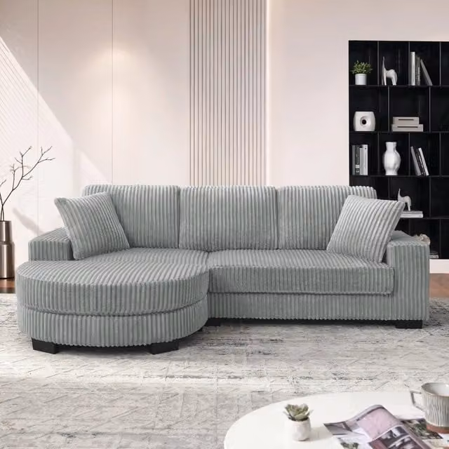 Divano angolare a L MIVRAY in velluto a coste grigio con pouf ovale reversibile e 2 cuscini L/P/H: 256,5 x 89 x 133,5 cm