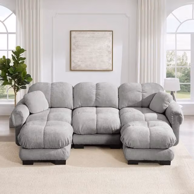 Divano panoramico a U Mivray in tessuto grigio con pouf coordinato e sedute imbottite, L: 260 cm, P: 149 cm, H: 90 cm