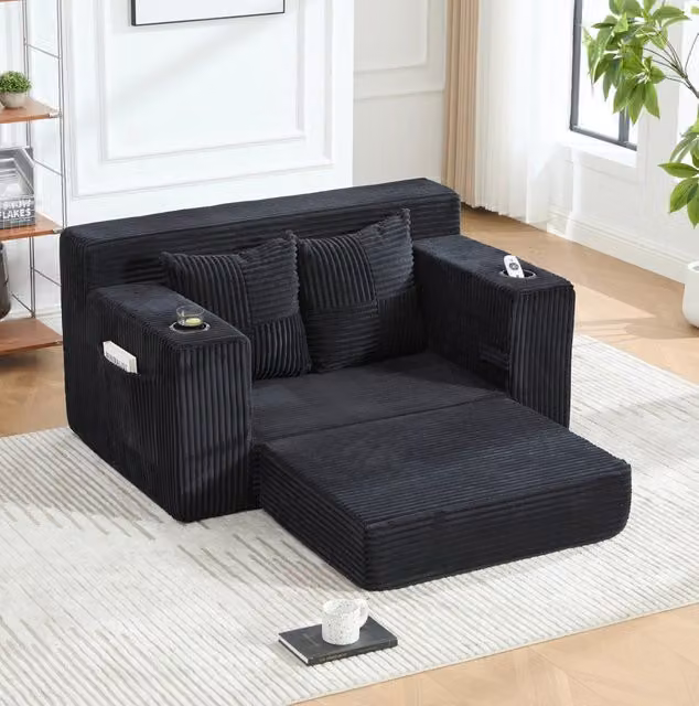 Divano pouf in velluto a coste nero con tasche laterali e 2 cuscini; 151 x 133 x 64 cm