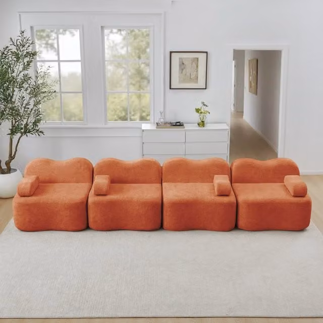 Divano angolare modulare MIVRAY in velluto arancione con pouf e cuscini coordinati per il tuo soggiorno