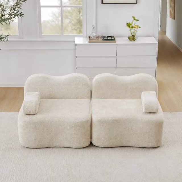 Divano modulare senza braccioli a forma ondulata con seduta profonda e cuscino bracciolo mobile in velluto beige