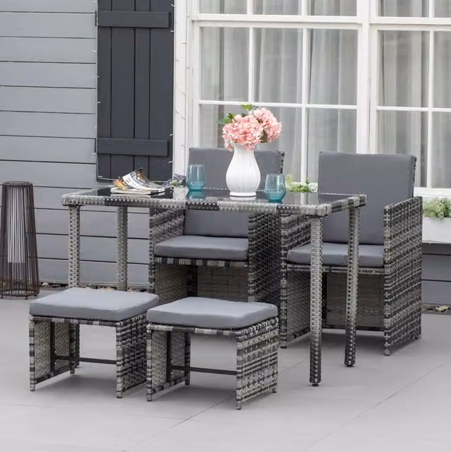 Salottino 5 pezzi in polyrattan grigio con cuscini e tavolo con piano in vetro
