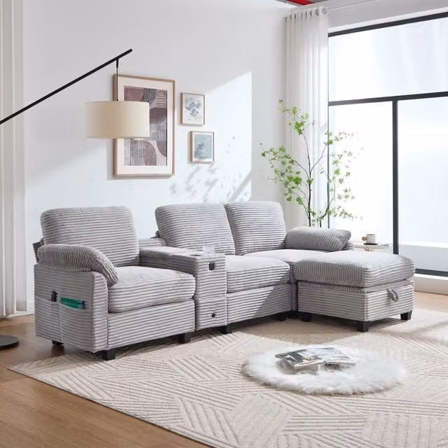 Divano moderno Mivray in velluto a coste grigio con pouf coordinato, porta tazze e ricarica USB-C, L: 266 cm, P: 136 cm, H: 82 cm