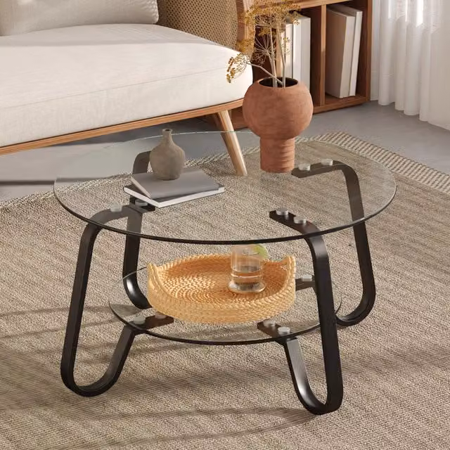 Tavolino basso fisso rotondo a due ripiani in metallo nero e vetro trasparente dal design industriale per soggiorno