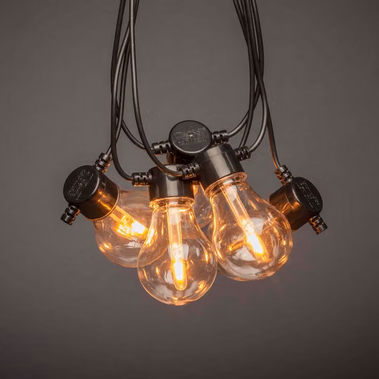 Konstsmide - Catena luminosa LED per esterno, trasparente, con dimmer, 10 lampadine trasparenti / 20 diodi ambrati, trasformatore esterno da 24 V, cavo nero. - 2391-800
