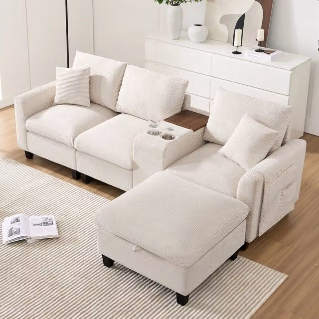 Divano angolare modulare MIVRAY a 4 posti in velluto a coste beige con console USB, portabicchieri e pouf contenitore incluso L/P/H: 229 x 149,5 x 83 cm