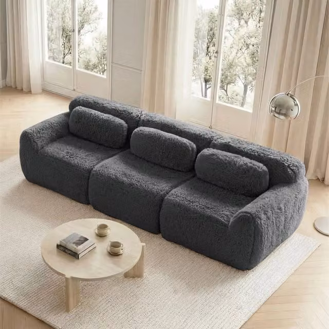 Divano angolare modulare senza struttura con seduta ampia e base antiscivolo in tessuto peluche grigio per soggiorno