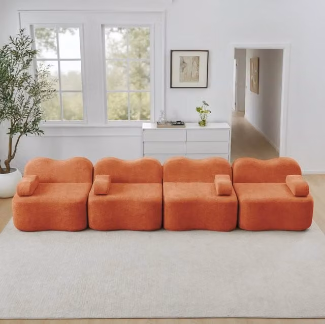 Divano modulare da soggiorno in velluto arancione; design ondulato con seduta profonda