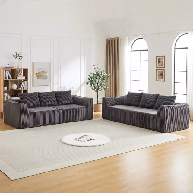 Divano modulare in velluto a coste con linee sinuose e seduta ampia, per soggiorno e relax quotidiano, grigio