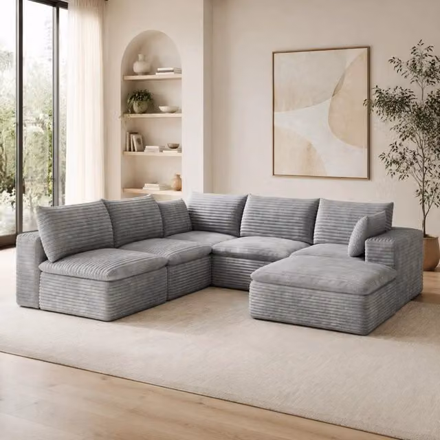 Divano modulare in tessuto grigio con supporto in schiuma; configurazione componibile