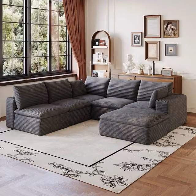 Divano modulare in tessuto grigio scuro con imbottitura in schiuma e configurazione flessibile