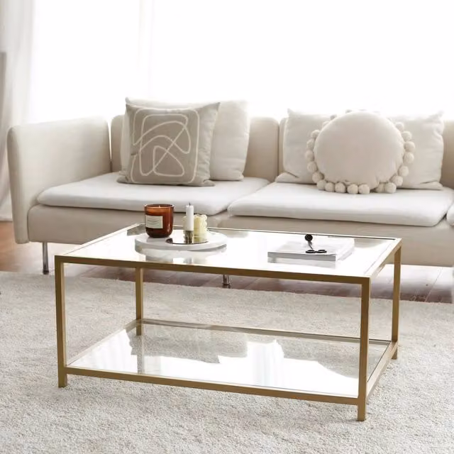 Tavolino da salotto Mina DMORA con piano in vetro trasparente e struttura oro, L: 90 cm, P: 60 cm, H: 40 cm