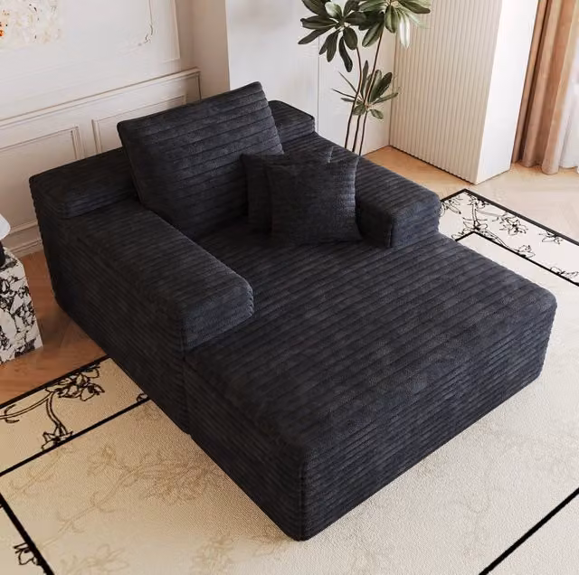 Divano chaise longue ULEVR in velluto a coste nero, seduta ampia in schiuma elastica, senza montaggio