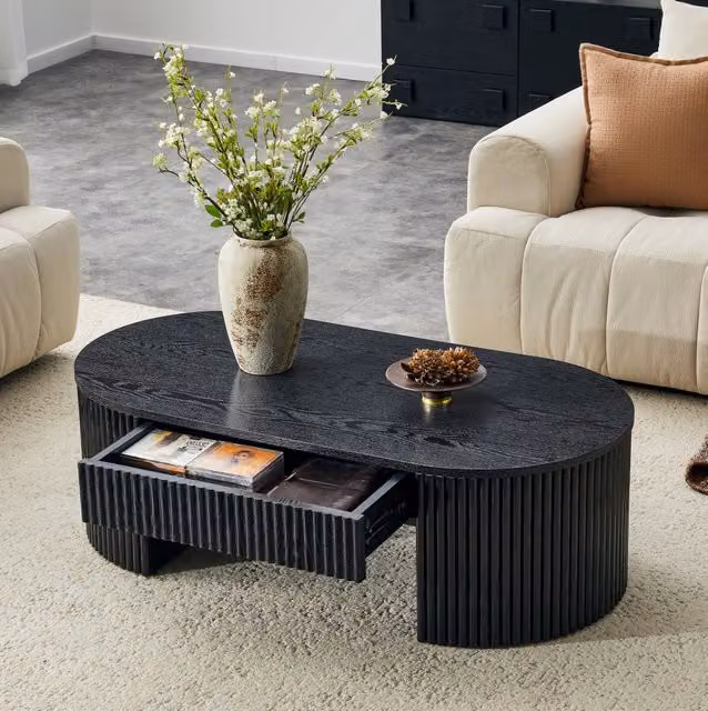Tavolino da salotto ovale ULEVR nero con cassetto estraibile e rivestimento laterale scanalato in MDF