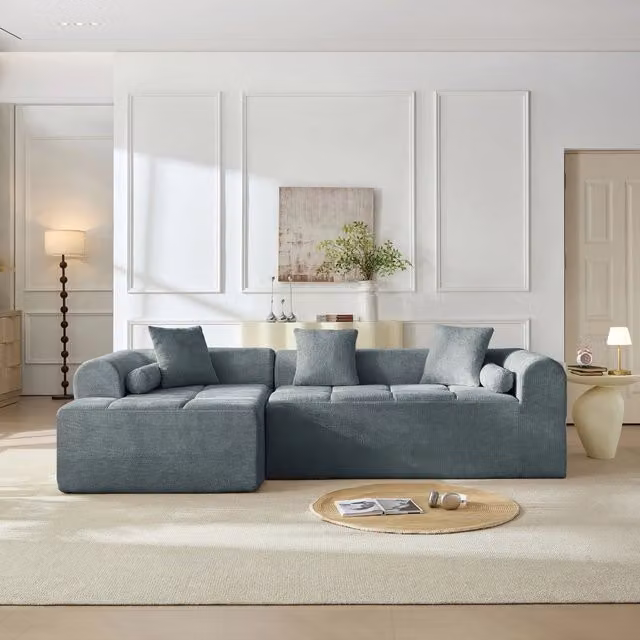Divano angolare in chenille blu con tasca laterale; imbottitura in schiuma e molle