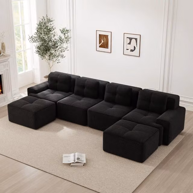 Divano modulare a L OKWISH in tessuto nero per soggiorno con seduta in schiuma e design moderno