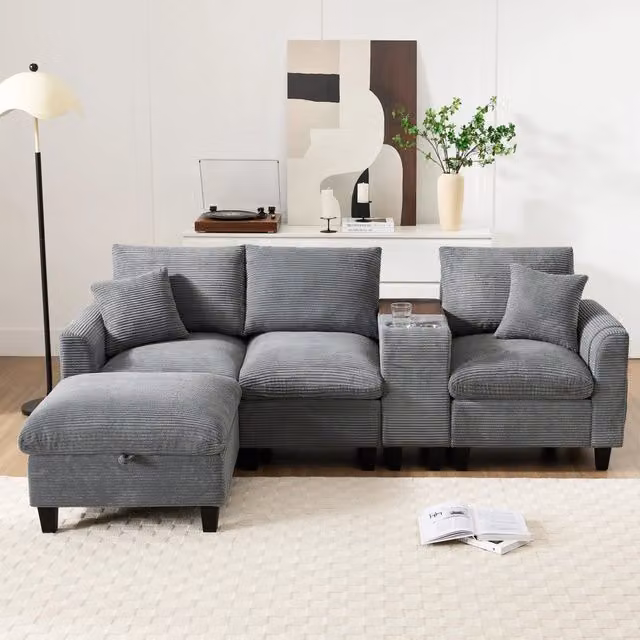 Divano angolare Mivray a L in velluto a coste grigio con pouf, console USB e portabevande, L 229 x P 149,5 x H 83 cm