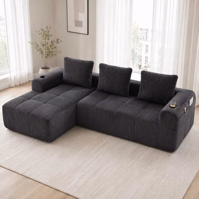 Divano modulare a L MIVRAY in velluto a coste grigio scuro con tasche portabevande e 3 cuscini inclusi L/P/H: 253 x 158 x 61 cm