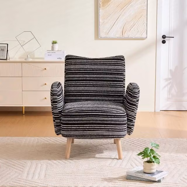 Poltrona relax Minimal in tessuto bouclé nero con motivi a pois, gambe in legno e tasca laterale per soggiorno, camera o ufficio