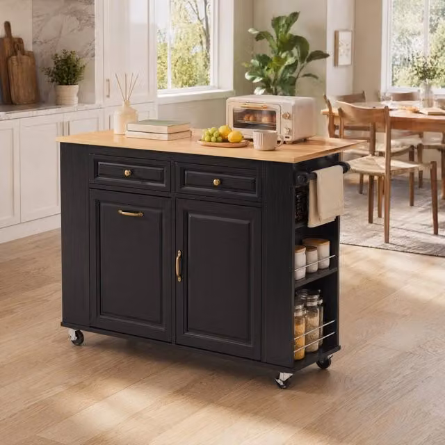 Isola cucina mobile nera con piano allungabile, portaro utensili, vano portapattumiera e prese elettriche integrate