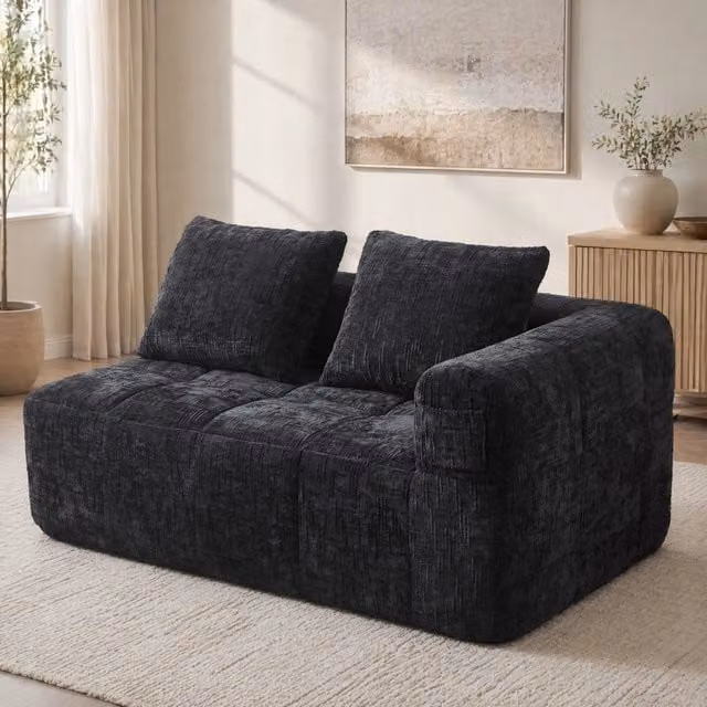 Divano chaise longue moderno 158x90x60 cm in chenille nera con cuscino e tasche laterali