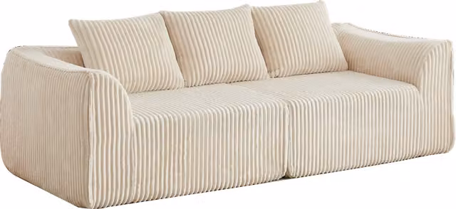 Divano modulare con schienale e braccioli curvi, seduta ampia e due cuscini in velluto a coste beige