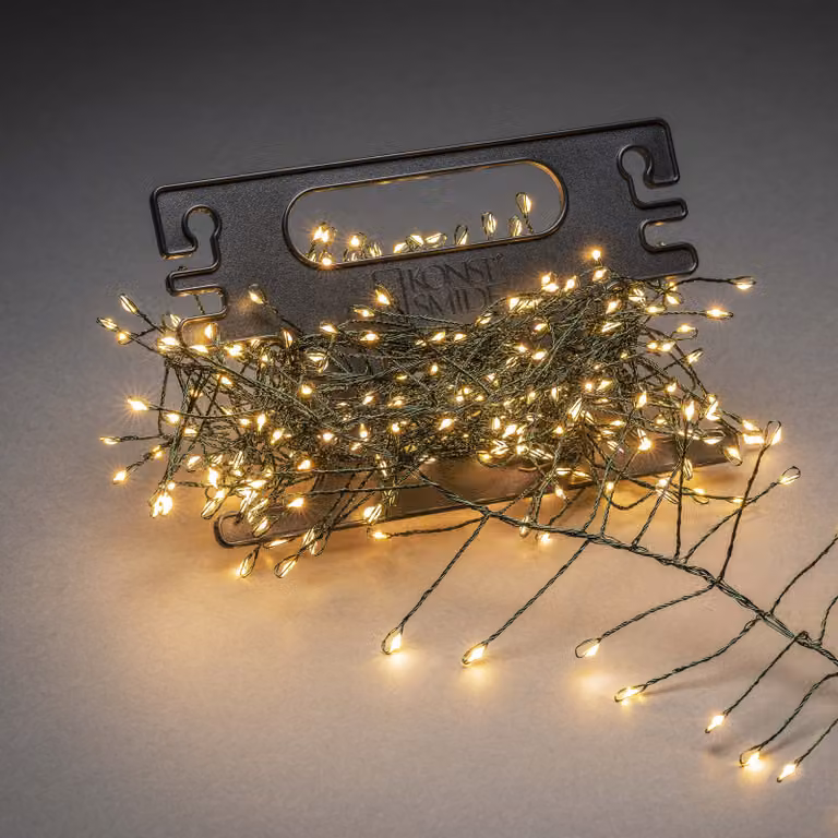 Catena luminosa Konstsmide Micro LED, con riavvolgitore, 200 diodi color ambra, trasformatore da 12 V per esterni, filo verde scuro - 6470-830