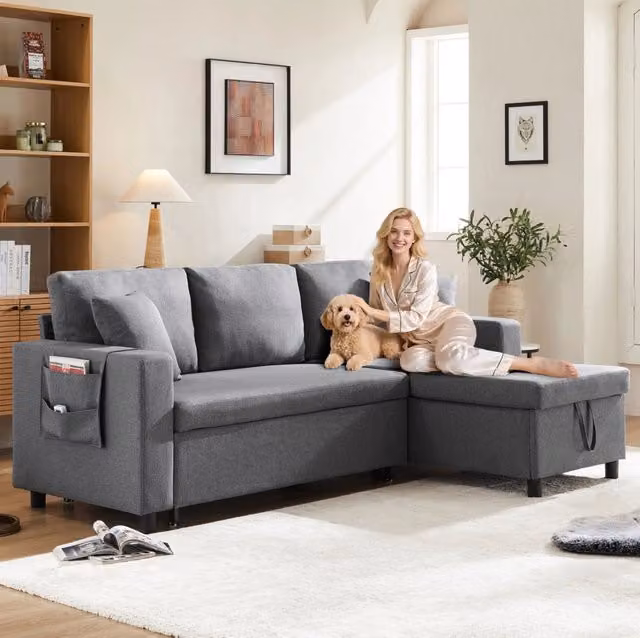 Divano letto angolare ULEVR 219,5x142,5 cm con chaise longue reversibile, vano contenitore e tasche laterali, grigio scuro