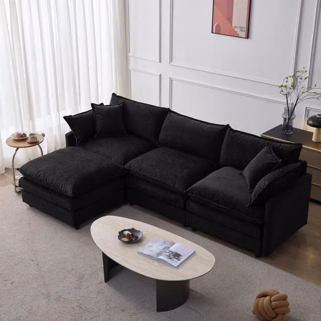 Divano angolare a L Vovees Living in velluto nero con pouf coordinato e cuscini, reversibile e moderno, L: 267 cm, P: 154 cm, H: 83 cm