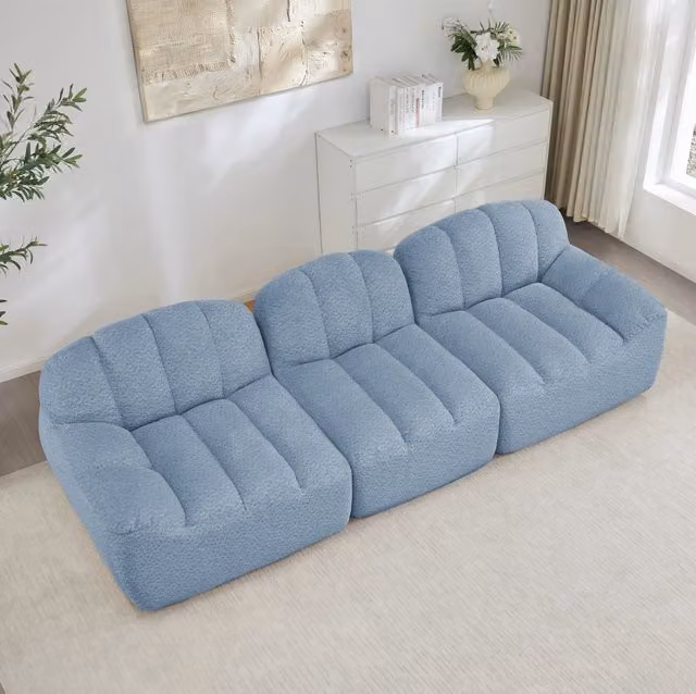 Divano modulare ad angolo in fleece granulare blu; design senza struttura e seduta ampia