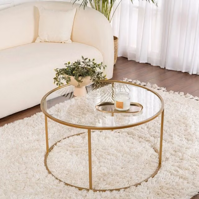 Tavolino da salotto Moena DMORA rotondo con piano in vetro trasparente e struttura oro L: 80 cm, P: 80 cm, H: 43 cm