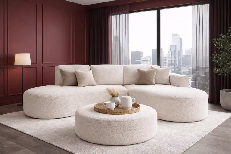 Divano angolare moderno Sofello, con forme arrotondate, modello MOLLY, con funzione letto + pouf da 100 cm, rivestito in tessuto bouclé FREDO color crema. Set moderno per il soggiorno