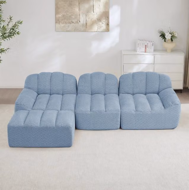 Divano angolare modulare senza struttura rigida con ottoman collegabile; pile granulato blu