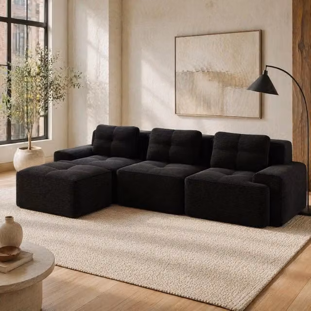 Divano modulare a L 293x177x69 cm in velluto a coste nero con pouf, per soggiorni attivi –
