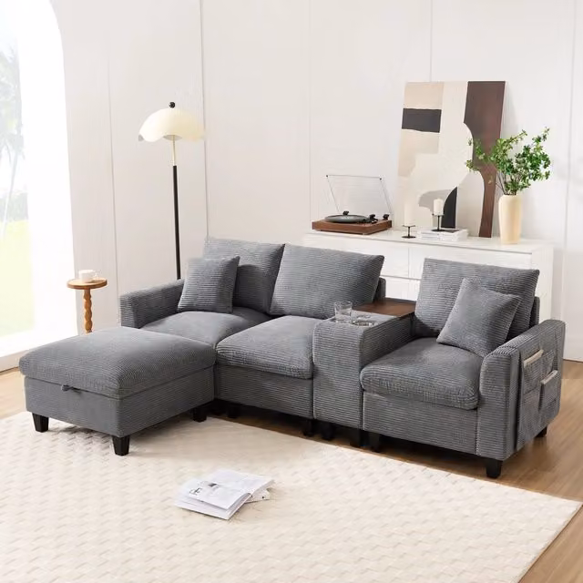 Divano angolare a L REDOM in velluto a coste grigio con pouf, 2 cuscini, porta bicchieri e ricarica USB, L/P/H: 229 x 149,5 x 83 cm