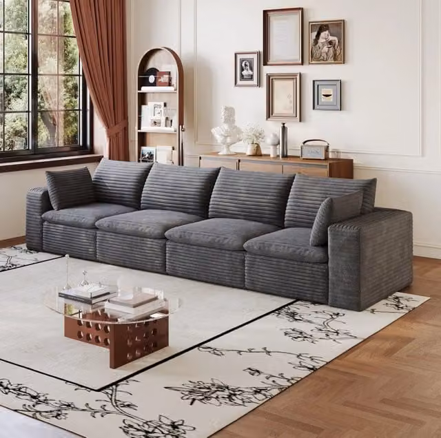 Divano modulare in tessuto grigio scuro con supporto in schiuma; design componibile